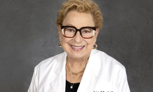 Dr. Sylvia Regalla headshot in a white coat